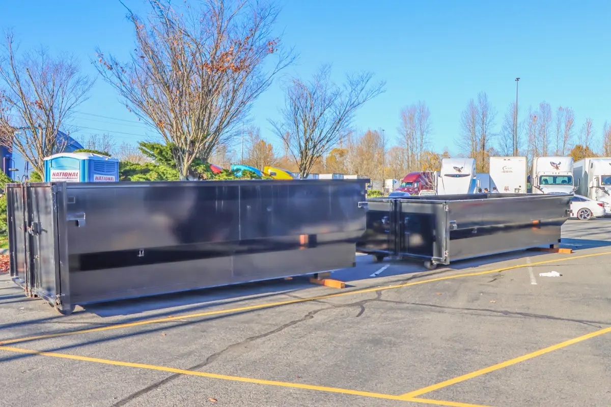 Professional dumpster rental service with roll-off container on residential driveway in Ulysses